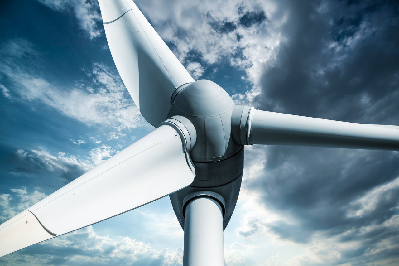 Wind turbine against stormy sky