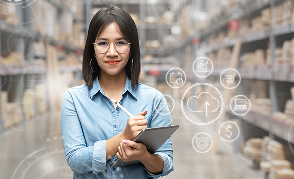 Young woman entrepreneur taking inventory on tablet