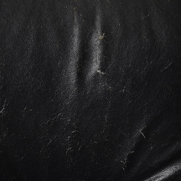 Torn black leather seat included sponge inside. Upholstery, ripped and tear old leather sofa. black leather texture background.
